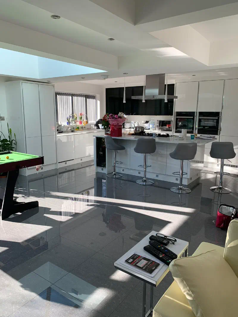 The finished kitchen with an island and breakfast bar in the open-plan extension